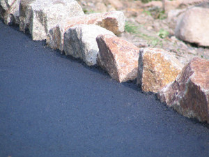 Stunning large rock feature edged driveway designs