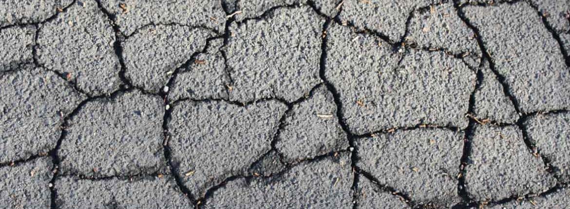 Cracked asphalt needing asphalt repairs
