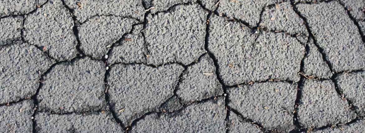 Cracked asphalt needing asphalt repairs